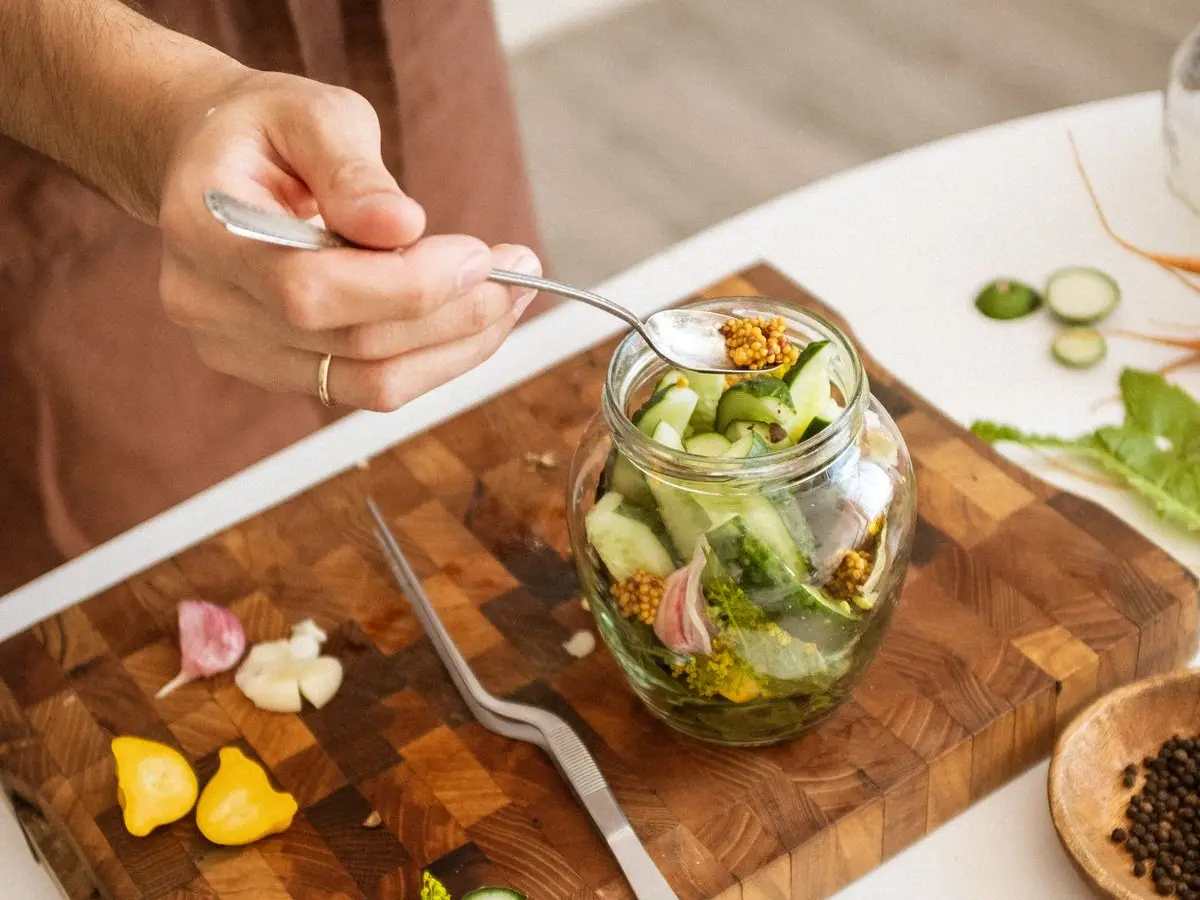 ガラス瓶に野菜を漬けている手元